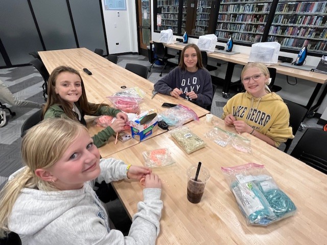 Four teems smiling while crafting