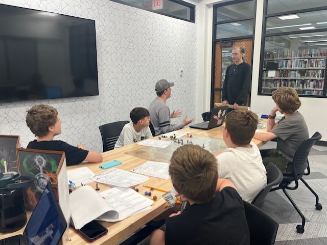 Teens playing a game of Dungeons and Dragons inside the library