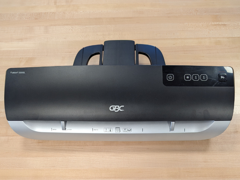 Black GBC Fusion 3000L Laminator machine sitting on a wooden table