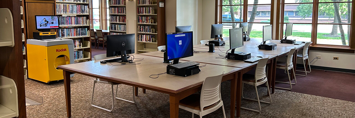 Six desktop computers located inside the library