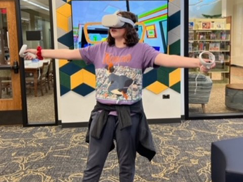 Girl playing with a virtual reality headset