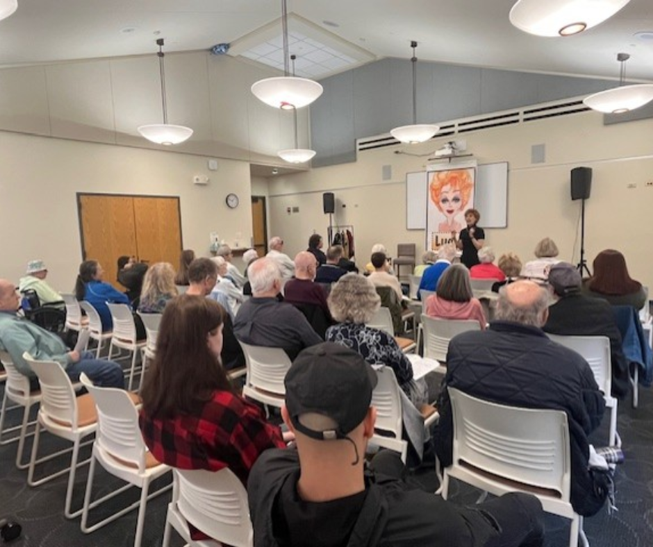 Several people using a meeting room for a meeting