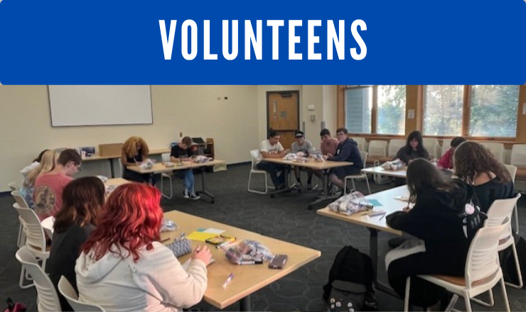 Teens seated at tables in circle