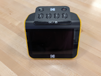 Black and yellow Kodak Slide N Scan machine sitting on a wooden table.